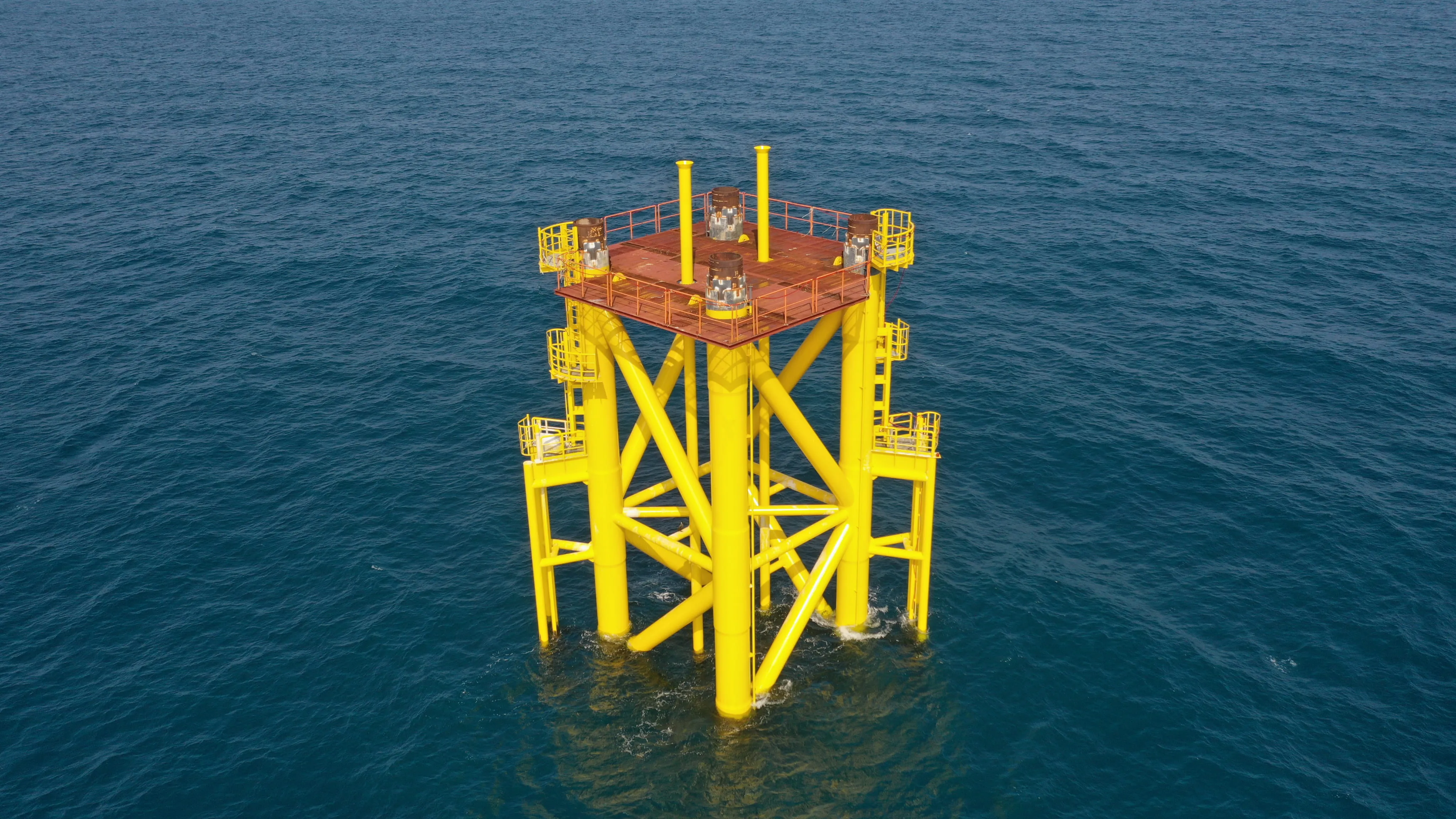 A yellow sea structure in the middle of the ocean